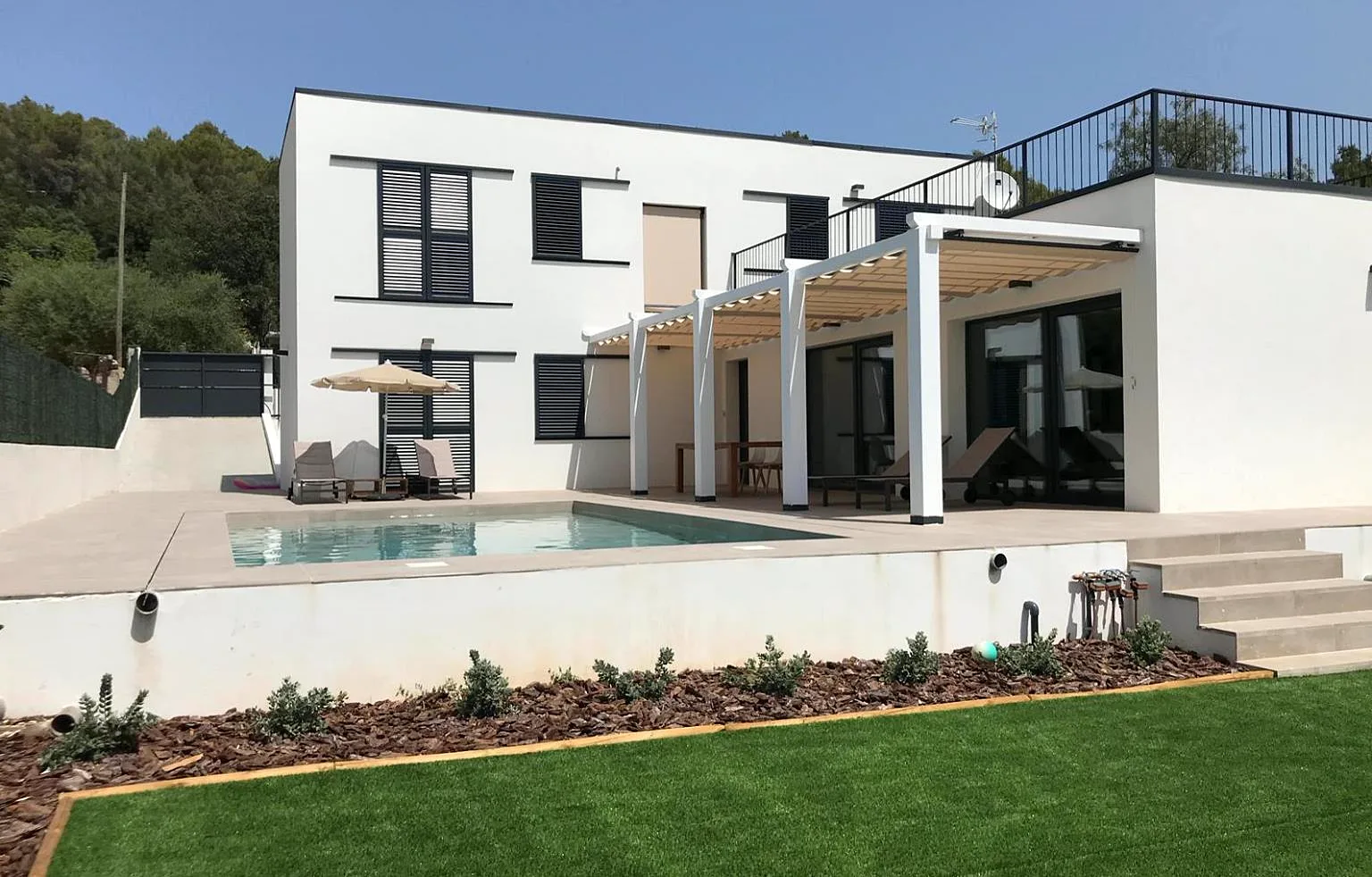 Casa de madera de entramado ligero de dos plantas con pérgola y piscina en Mallorca